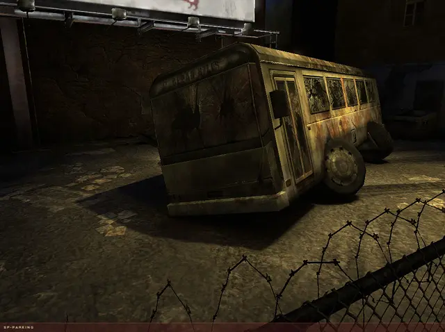 Wrecked bus by a fence