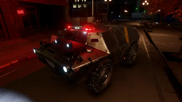 The APC at night, its red lights on
